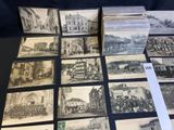 many old postcards on a table with a lot of them