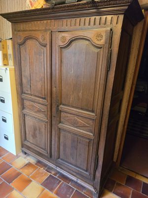 an image of a cupboard in a kitchen with tile flooring