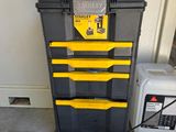 yellow and black toolbox with tools on the floor next to a white and black box
