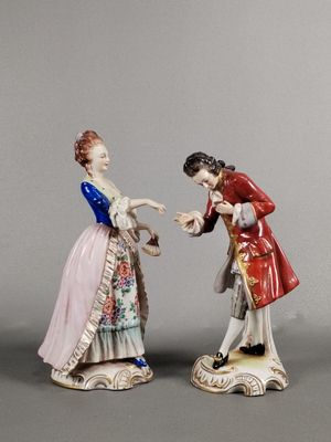 une paire de figurines représentant un homme et une femme se tenant la main