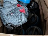 a cardboard box filled with assorted items sitting on the floor