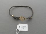 a bracelet that has a tag on it with a tag attached to it