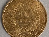 a close up of a gold coin on a white surface