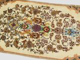 a close up of a rug on a table with a white background