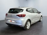 the rear end of a silver car in a showroom