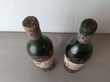 two bottles of wine that are sitting on a table