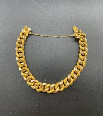 a gold necklace with a chain that is attached to it