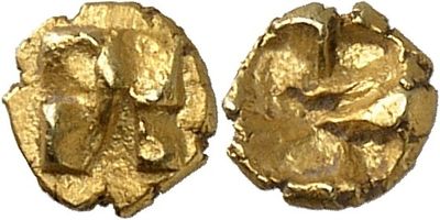 a close up of a gold coin with a face on it
