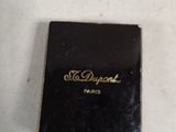 a small black book on a white table