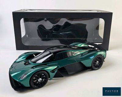 green and black model of a sports car in front of a black box
