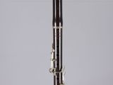 a close up of a clarinet on a table with a white background
