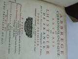 an old book with a black and red design on it
