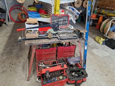 a workbench with tools on it in a garage