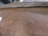 a close up of a brown shoe with a label on it