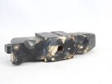 a small black object that is sitting on a white surface