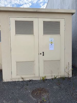 two doors that are open on the side of a building