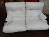 two white couches sitting next to each other on the floor
