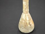 an old glass vase with a small hole in the middle