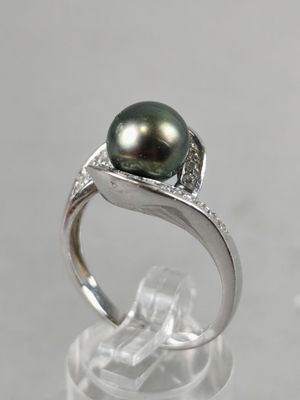 an image of a ring with a black pearl and diamonds