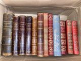 many old books in a cardboard box on the table