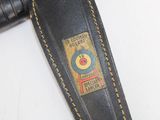 a black leather belt with a yellow stitching on it