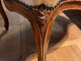 a wooden chair with a white upholstered upholstered seat