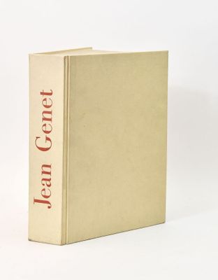 an old book sitting on top of a white table next to a white wall