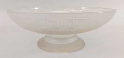 white glass bowl sitting on top of a pedestal on a white surface