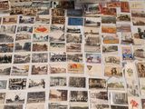 a lot of old postcards on the table