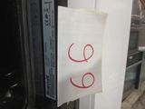 a sticker on the door of a microwave with a smiley face drawn on it