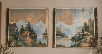 two paintings hanging on the wall above a couch