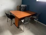 a table and chairs in a room with a blue wall