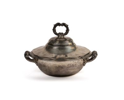 an antique silver plate with a lid and handles on a white background