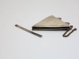 a small silver purse with a chain around it