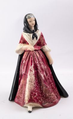 une image représentant une figurine de femme en robe rouge