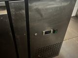 a stainless steel freezer sitting on the floor in a kitchen
