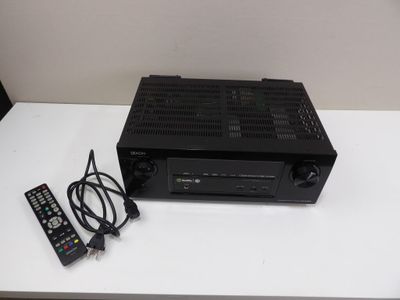 a remote control and a receiver on a white table