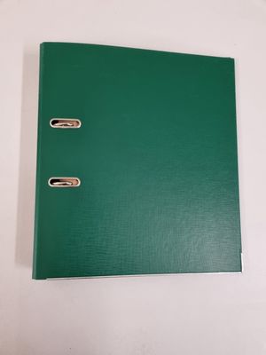 a green binder sitting on top of a white table