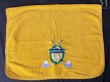 a close up of a yellow towel with a crest on it