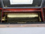 a wooden box with a musical box inside of it