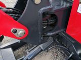 a close up of a red tractor with a black seat