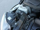 a car engine with its hood open on the street