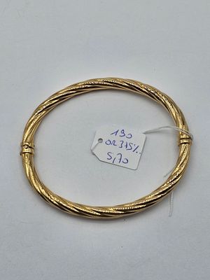 a close up of a gold bracelet with a price tag on it
