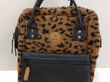 leopard print backpack with black leather handles and a brown and black purse