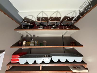 a shelf that has a bunch of dishes on top of it
