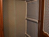 an image of a closet in a house with blue and brown wallpaper