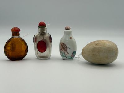 three small glass bottles sitting next to each other on a white surface