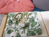 a pair of gold scissors sitting on top of a green and white purse