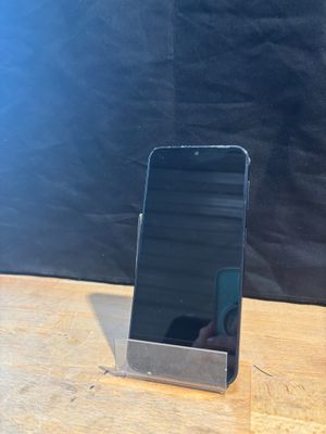 a cell phone that is sitting on top of a wooden table