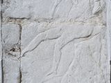 une plaque en pierre fixée sur le côté d'un mur de briques